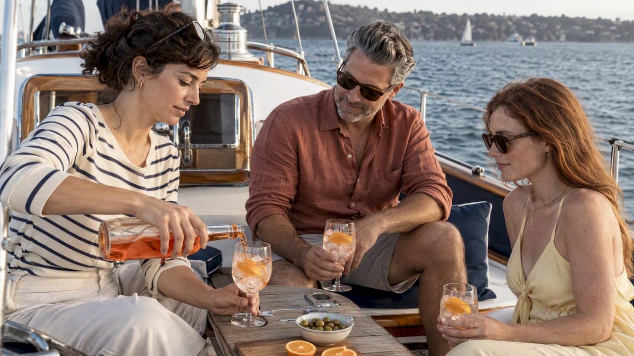 Guests share spritzes aboard a themed yacht party